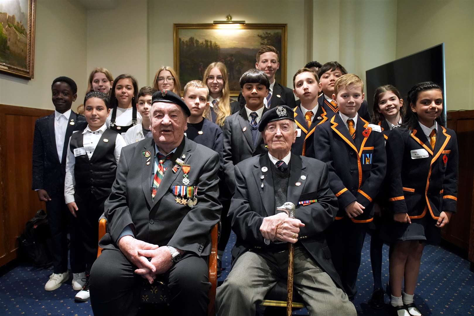 D-Day veterans Richard Aldred (left), 99, and Stan Ford, 98, meeting school children at the Union Jack Club in London (Gareth Fuller/PA)